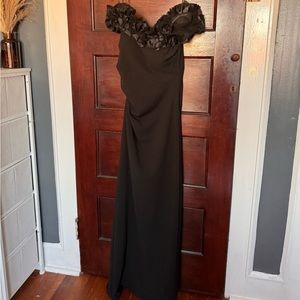 Black strapless, off the shoulder, gown.